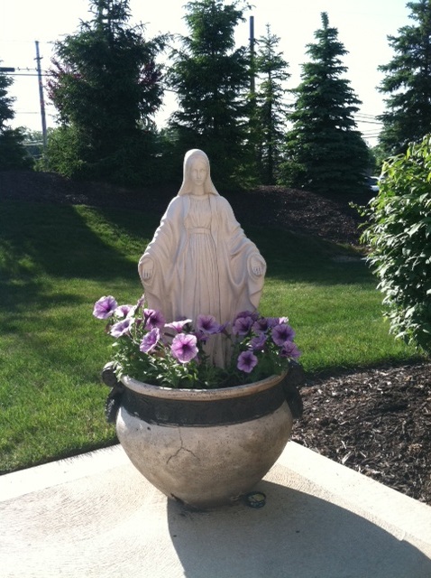 Even if you live in a town home or apartment, you can have a Marian garden on your porch! This creative display is pretty and portable...you don't even need a yard to maintain it.