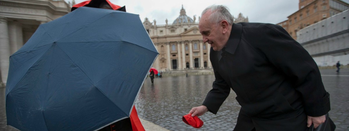 Pope Francis (when he was Bergoglio) helping another cardinal catch his hat in the wind